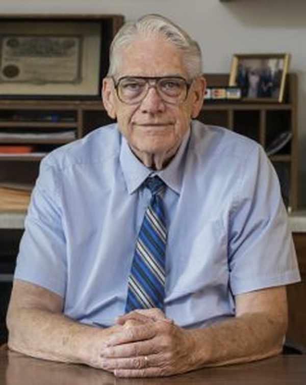 Dr. Jim Talley seated at his desk in his counseling office